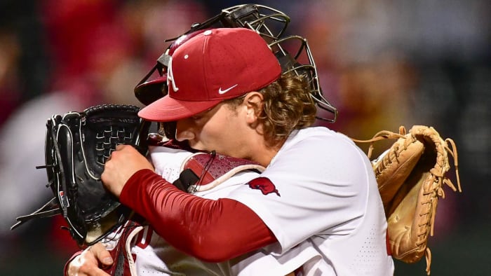 Razorbacks pitcher Hagen Smith embraces catcher Parker Rowland after win